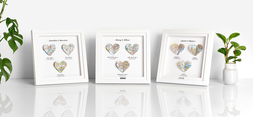 Personalised Memories Mapped Frame with 3D heart-shaped maps showing special locations in white shadow box frames.