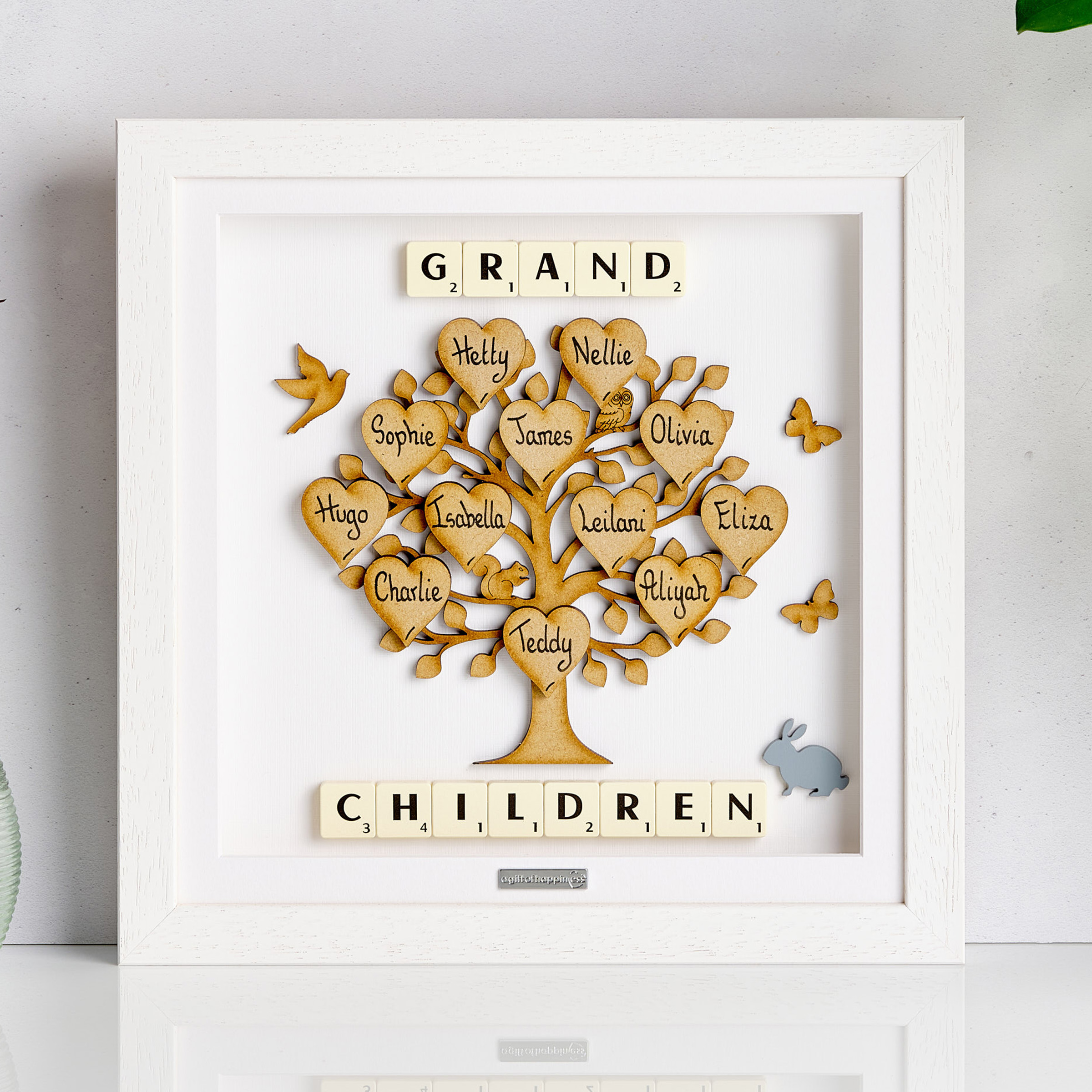 Personalised wooden family tree frame with handwritten heart names and Scrabble tiles spelling “Grandchildren