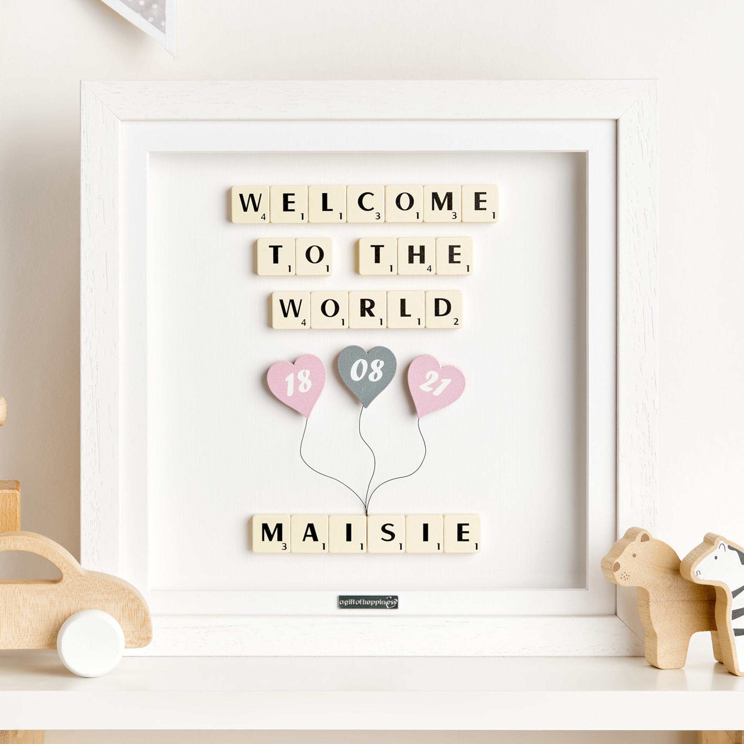 Personalised new baby girl frame with Scrabble tiles and pink heart balloons showing birth date and name