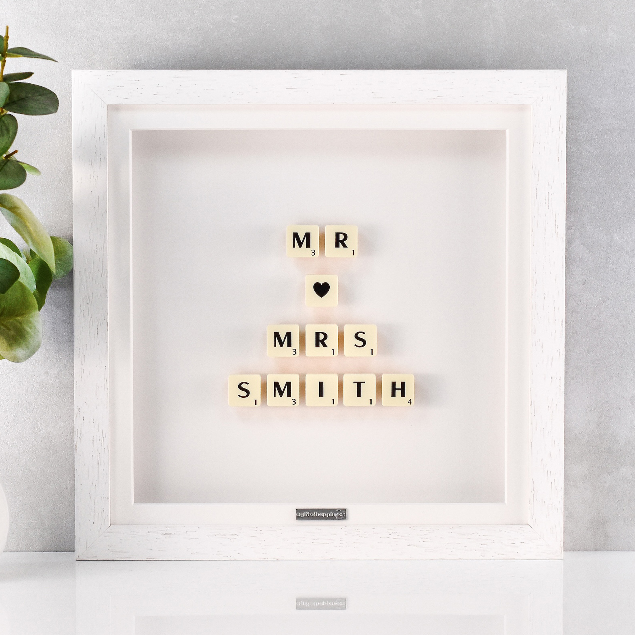 Personalised wedding gift frame with Scrabble tiles spelling “Mr ♥ Mrs” and married surname in white box frame