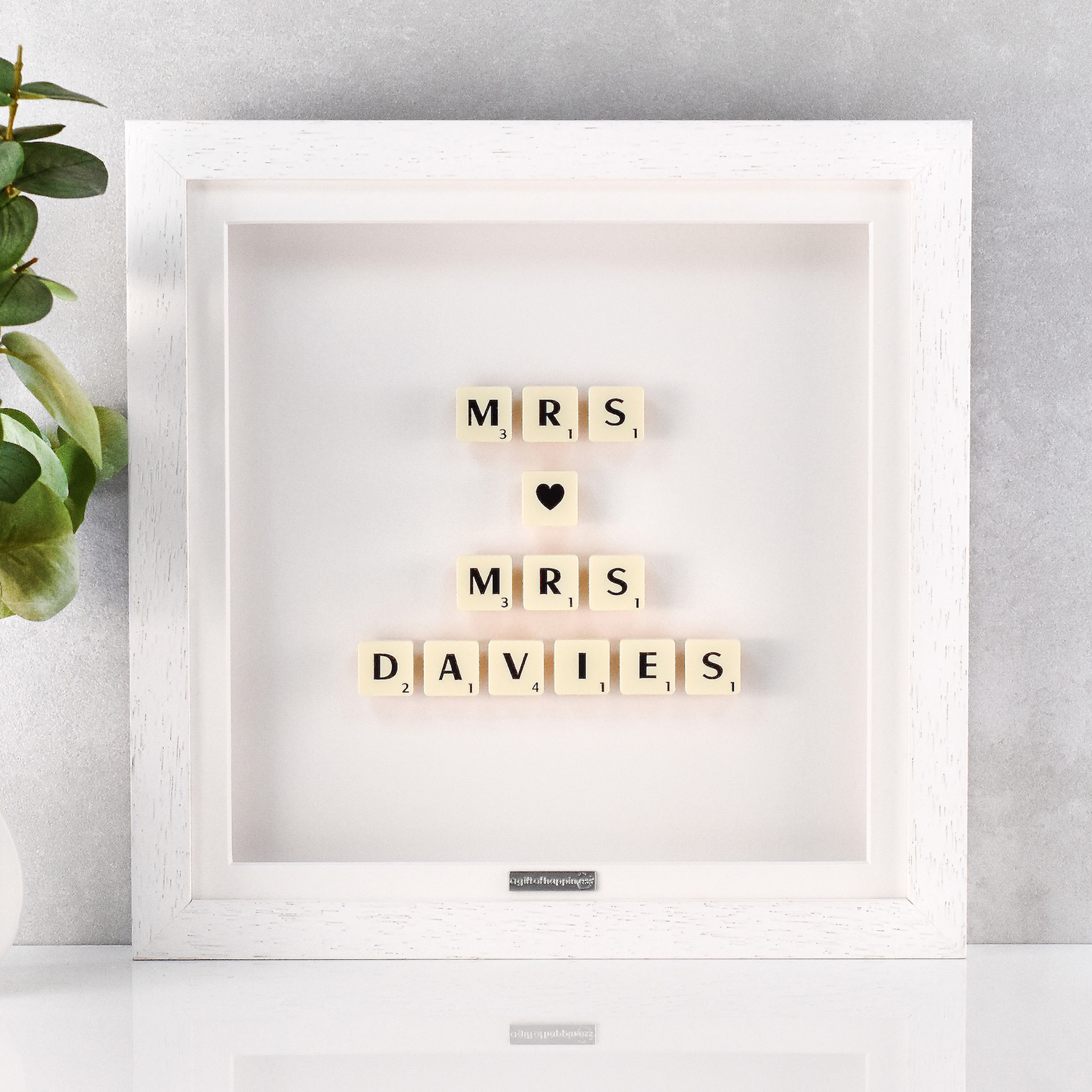 Personalised wedding gift frame with Scrabble tiles spelling “Mrs ♥ Mrs” and married surname in white box frame