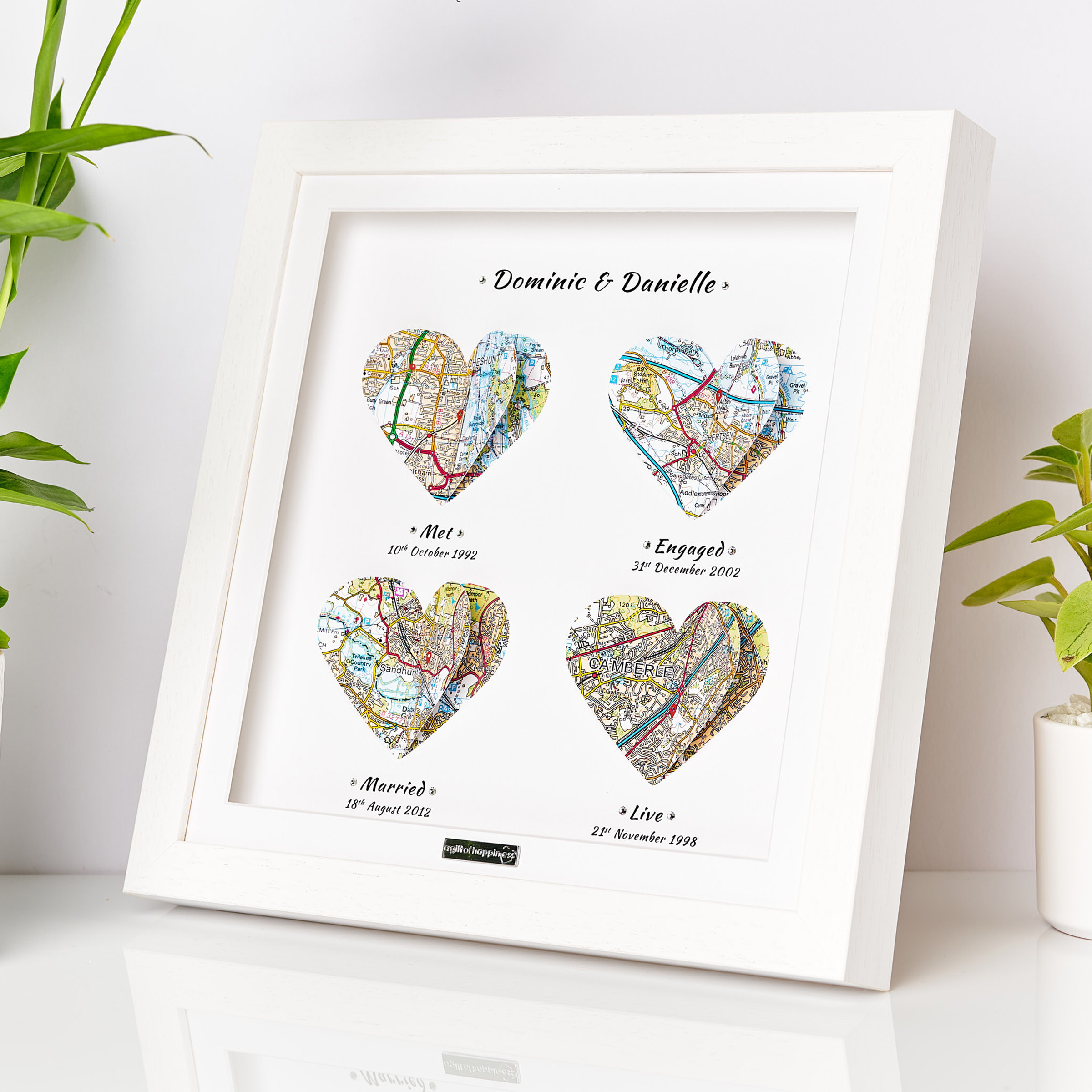 Personalised romantic map print with four heart-shaped maps marking special relationship milestones